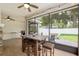 Screened porch with outdoor kitchen, outdoor dining, and nice view of backyard at 3883 Se 51St Ct, Ocala, FL 34480