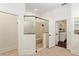 Bathroom featuring an enclosed shower with bench, a glass door, and an attached dressing room at 3883 Se 51St Ct, Ocala, FL 34480