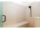 Modern shower featuring light tile, bench, and shower head with handle at 3883 Se 51St Ct, Ocala, FL 34480