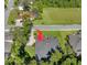 Aerial view of the roof of this home, featuring a dark roof, trees, and green lawn at 3993 Se 10Th Ave, Ocala, FL 34480