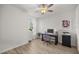 Bedroom with wood floors, window, ceiling fan, desk, and printer at 3993 Se 10Th Ave, Ocala, FL 34480