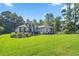 Expansive lawn and meticulously maintained landscaping highlight the home's facade at 3993 Se 10Th Ave, Ocala, FL 34480