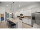 Contemporary kitchen with stainless appliances, granite counters, and an island with bar stools at 3993 Se 10Th Ave, Ocala, FL 34480