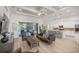 Open-concept living space with sliding doors and a modern kitchen and patio access at 3993 Se 10Th Ave, Ocala, FL 34480