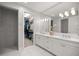 Bright main bathroom featuring a double vanity and a walk-in closet with ample storage at 3993 Se 10Th Ave, Ocala, FL 34480