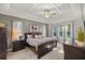 Elegant main bedroom features a decorative tray ceiling, lots of natural light, and neutral walls at 3993 Se 10Th Ave, Ocala, FL 34480