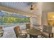 Covered outdoor patio area with a ceiling fan, and comfortable chairs at 3993 Se 10Th Ave, Ocala, FL 34480