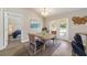 Cozy dining area with natural light, wood table, and adjacent access to a bedroom at 4 Dogwood Run, Ocala, FL 34472