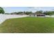 Wide, fenced backyard with lawn, brick patio, and screened in porch at 4531 Se 27Th St, Ocala, FL 34480
