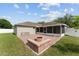 A brick patio features a firepit, bordering the house and lawn at 4531 Se 27Th St, Ocala, FL 34480