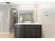 Bathroom boasting a double sink vanity and access to walk-in closet via arched doorway at 4531 Se 27Th St, Ocala, FL 34480