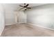 Bright bedroom featuring neutral carpet, ceiling fan, and a convenient entry door at 4531 Se 27Th St, Ocala, FL 34480