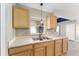 Well-lit kitchen features wood cabinets, stainless steel sink, and a view to the backyard at 4531 Se 27Th St, Ocala, FL 34480