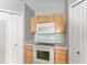 A partial view of a kitchen that features an oven, microwave and lots of cabinet space for storage at 4531 Se 27Th St, Ocala, FL 34480