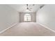 Spacious living room features vaulted ceilings, carpet flooring and a large arched window at 4531 Se 27Th St, Ocala, FL 34480