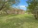 Spacious backyard featuring lush green grass and mature trees providing ample shade at 5 Bahia Circle Pl, Ocala, FL 34472