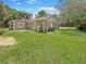 Expansive backyard featuring lush green grass, mature trees, and new concrete patio at 5 Bahia Circle Pl, Ocala, FL 34472