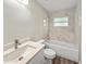 Bright bathroom with a vanity, toilet, and tub with tiled shower at 5 Bahia Circle Pl, Ocala, FL 34472