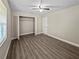 Bright bedroom featuring a closet with folding doors and wood-look vinyl flooring at 5 Bahia Circle Pl, Ocala, FL 34472