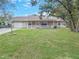 Charming single-story home features a well-manicured lawn and inviting front porch with white railing at 5 Bahia Circle Pl, Ocala, FL 34472