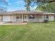 Charming single-story home with a covered front porch and freshly cut, green lawn at 5 Bahia Circle Pl, Ocala, FL 34472