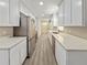 Modern kitchen featuring stainless steel appliances, white cabinetry, and sleek countertop at 5 Bahia Circle Pl, Ocala, FL 34472