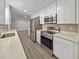 Well-equipped kitchen features stainless steel appliances, white cabinetry, and modern fixtures at 5 Bahia Circle Pl, Ocala, FL 34472