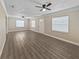 Bright and airy living room featuring new vinyl floors, fresh paint, and two ceiling fans at 5 Bahia Circle Pl, Ocala, FL 34472