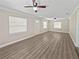 Bright and airy living room featuring new vinyl floors, fresh paint, and two ceiling fans at 5 Bahia Circle Pl, Ocala, FL 34472