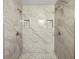 Modern shower with marble-look tile, dual shower heads, and convenient recessed shelving at 5 Bahia Circle Pl, Ocala, FL 34472