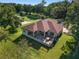 Expansive aerial view of the home showcasing the large lot, back patio, and lush landscaping at 5034 Nw 75Th Ave, Ocala, FL 34482