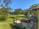 Inviting covered patio area with ample seating, ideal for entertaining while overlooking a scenic golf course view at 5034 Nw 75Th Ave, Ocala, FL 34482