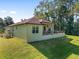 House with a spacious backyard, covered patio, and lush lawn at 5034 Nw 75Th Ave, Ocala, FL 34482