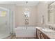 Bright bathroom featuring a soaking tub under a window, and a glass enclosed shower at 5034 Nw 75Th Ave, Ocala, FL 34482