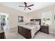 Comfortable bedroom features a ceiling fan, plush carpet, and natural light from the window at 5034 Nw 75Th Ave, Ocala, FL 34482