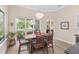 Bright dining room with views of the outdoor space and a lovely chandelier at 5034 Nw 75Th Ave, Ocala, FL 34482