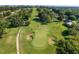 Aerial view of the golf course with sand traps and putting green at 5034 Nw 75Th Ave, Ocala, FL 34482