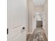 Hallway with wood look tile flooring and several doors leading to different rooms of the house at 5034 Nw 75Th Ave, Ocala, FL 34482