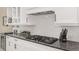 Close up on bright kitchen featuring granite countertops and stainless steel gas cooktop at 5034 Nw 75Th Ave, Ocala, FL 34482