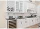 Bright kitchen featuring granite countertops, wine cooler and stainless steel gas cooktop at 5034 Nw 75Th Ave, Ocala, FL 34482