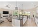 Open kitchen layout with granite countertops, pendant lighting, and seamless flow to the living area at 5034 Nw 75Th Ave, Ocala, FL 34482