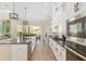 Open kitchen with granite countertops, stainless steel appliances, and seamless flow to the living area at 5034 Nw 75Th Ave, Ocala, FL 34482