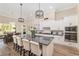 Bright, modern kitchen featuring granite countertops, a large island with seating, and stainless steel appliances at 5034 Nw 75Th Ave, Ocala, FL 34482