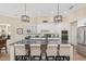 Elegant kitchen showcasing a granite island with seating, white cabinetry, and stainless steel appliances at 5034 Nw 75Th Ave, Ocala, FL 34482