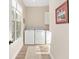 Bright laundry room with a full-size washer and dryer, window and tile flooring at 5034 Nw 75Th Ave, Ocala, FL 34482