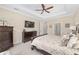 Comfortable main bedroom showcasing a ceiling fan, a calming color scheme, and pleasant view from the window at 5034 Nw 75Th Ave, Ocala, FL 34482