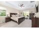 Well-lit main bedroom with a ceiling fan, neutral color palette, and ample natural light from large windows at 5034 Nw 75Th Ave, Ocala, FL 34482