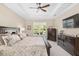 Spacious main bedroom featuring a ceiling fan, plush carpeting, and stylish furniture at 5034 Nw 75Th Ave, Ocala, FL 34482