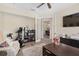 Functional home office with an exercise machine, a wall-mounted TV, and French doors at 5034 Nw 75Th Ave, Ocala, FL 34482