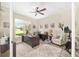Bright home office with a large window, desk, fan, and a comfortable seating area at 5034 Nw 75Th Ave, Ocala, FL 34482